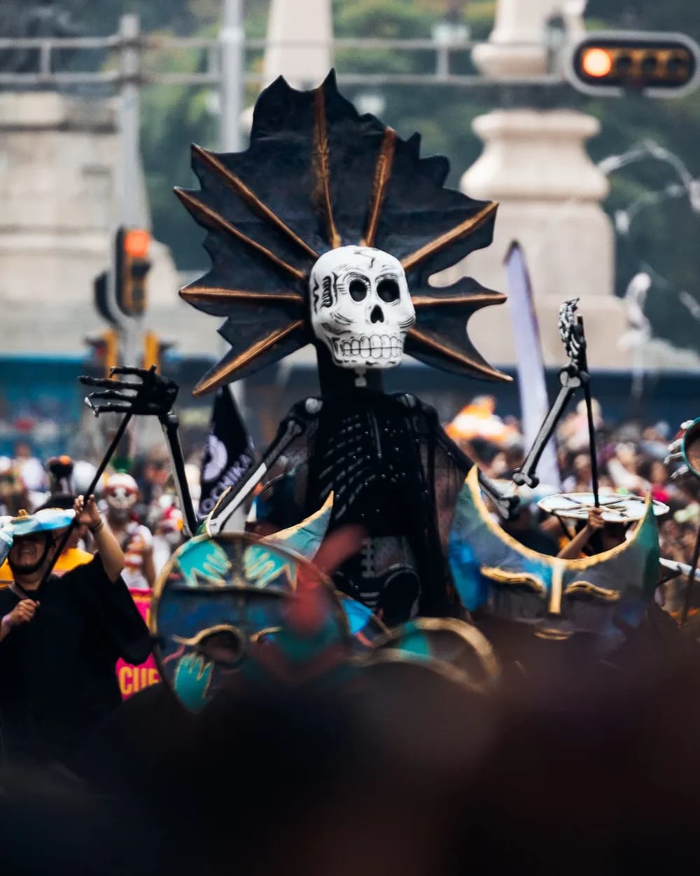 A giant skeleton figure carried in a Día de Muertos procession